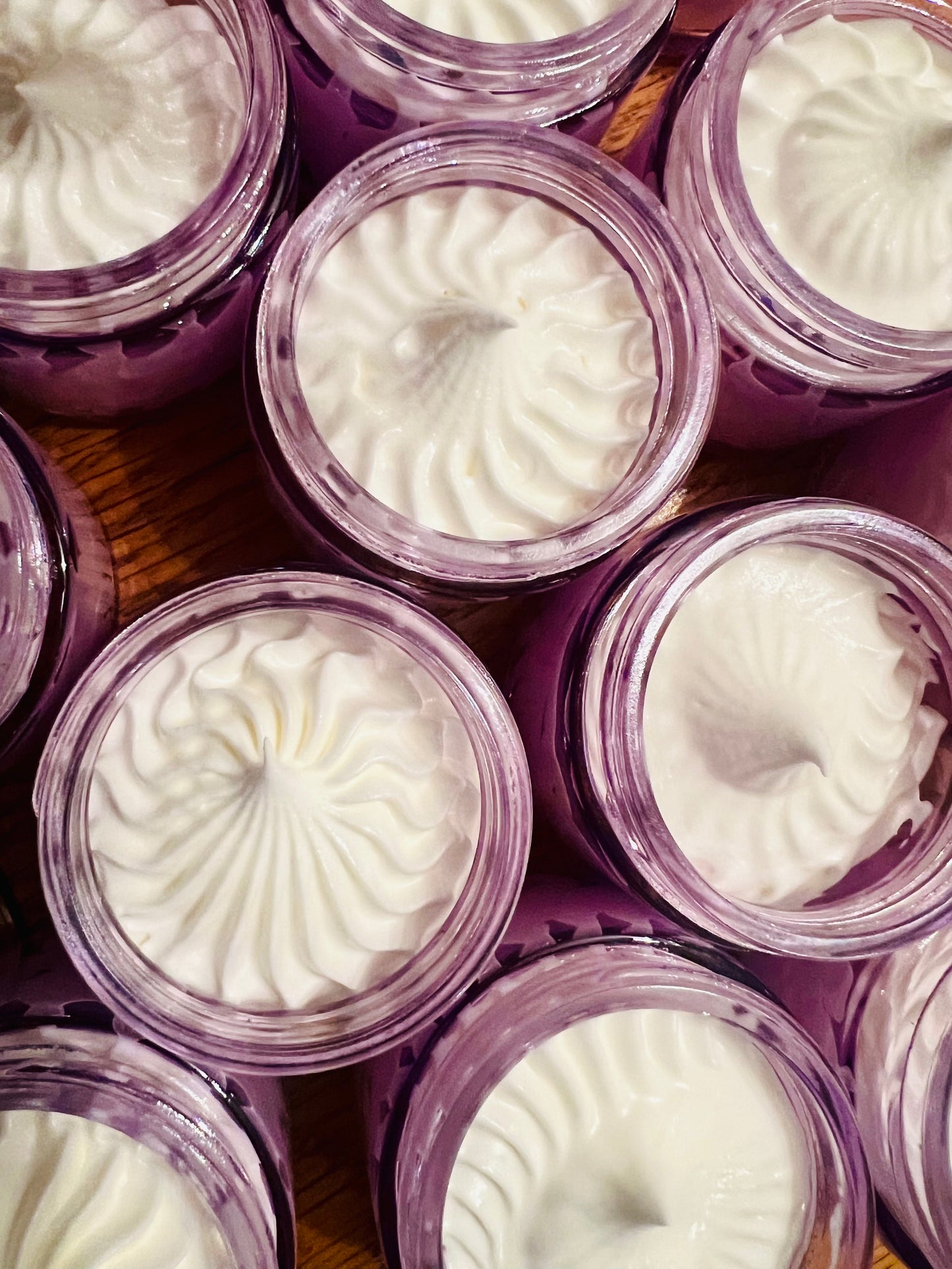 Beautiful and creamy whipped lavender tallow in light purple glass jars.