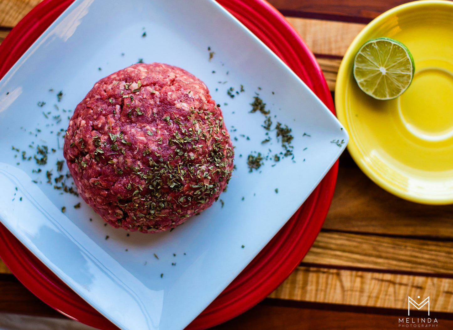 Plate of farm-raised 90% lean ground beef, freshly cooked, showcasing the rich texture and quality of family-raised beef.