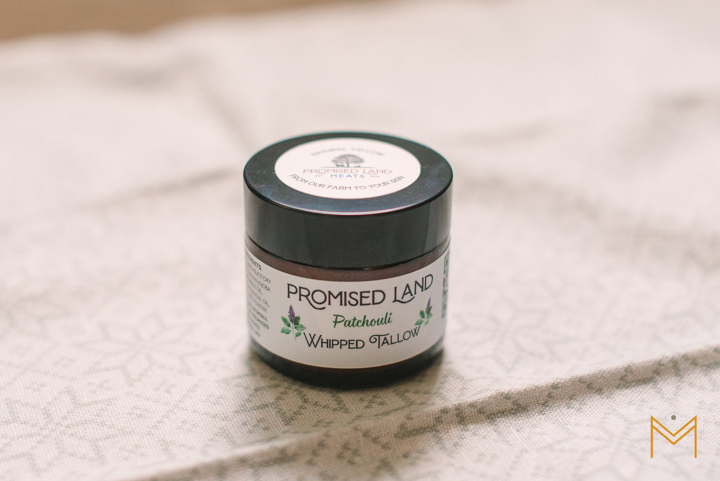 Natural patchouli whipped tallow skincare product on display